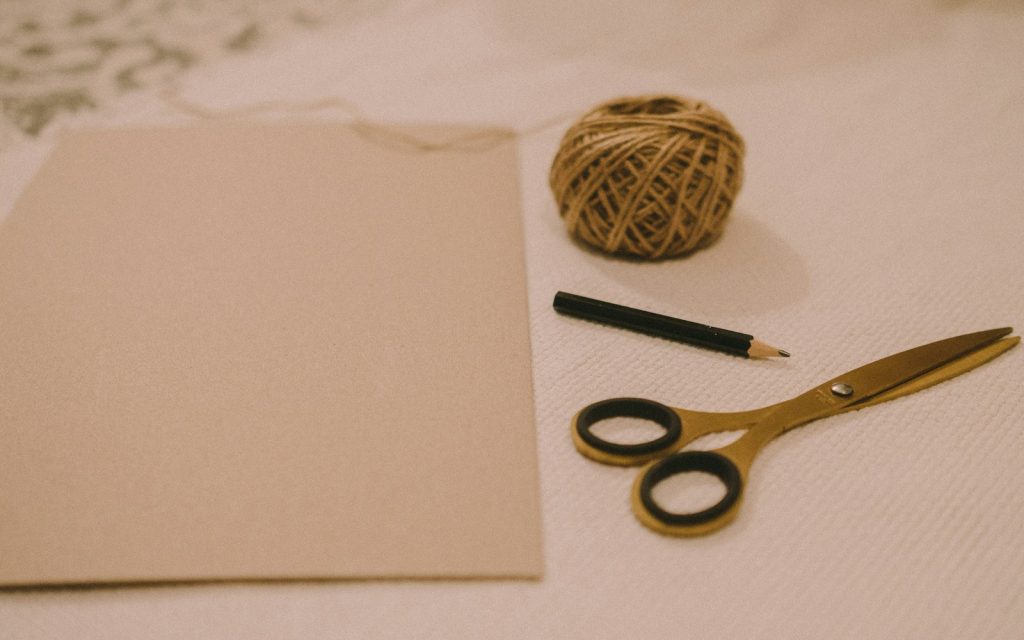 Black handled scissors on white printer paper